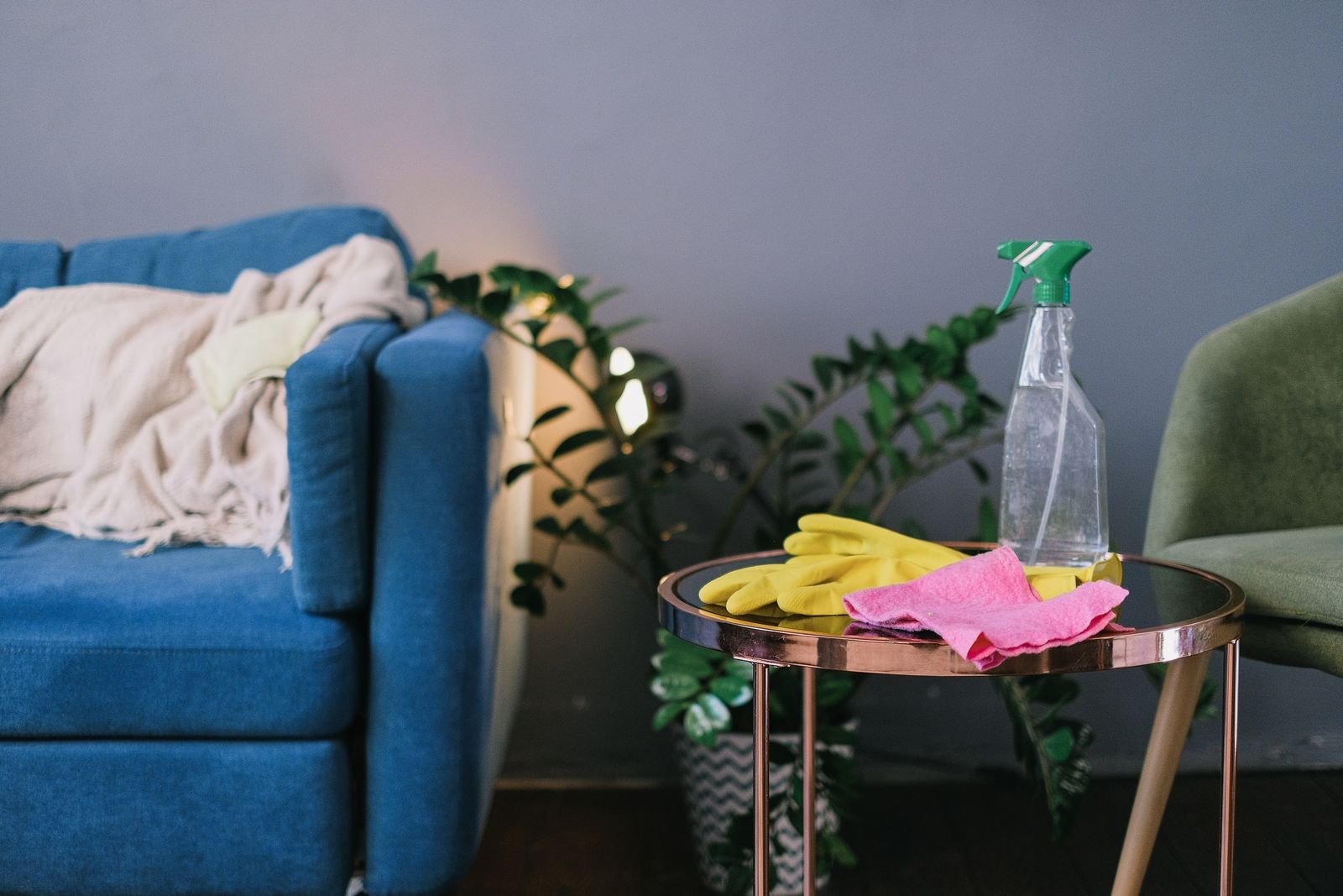 Cleaning products and gloves ready in a living room